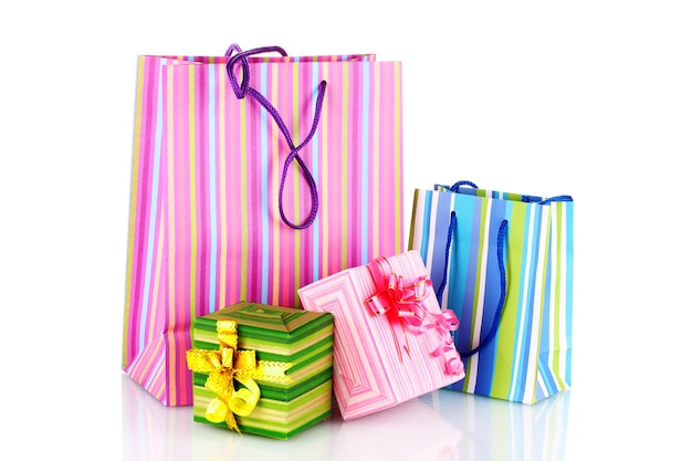 Bright gift bags and gifts isolated on white