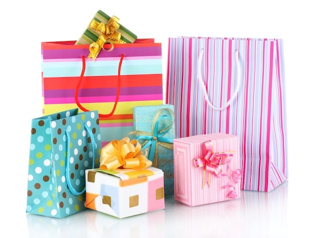 Bright gift bags and gifts isolated on white