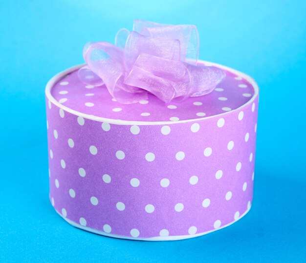 Bright gift with bow on blue background
