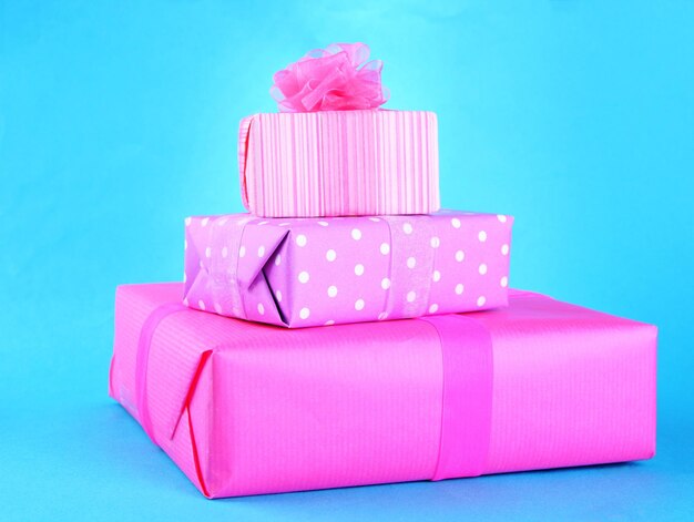 Bright gifts with bows on blue background