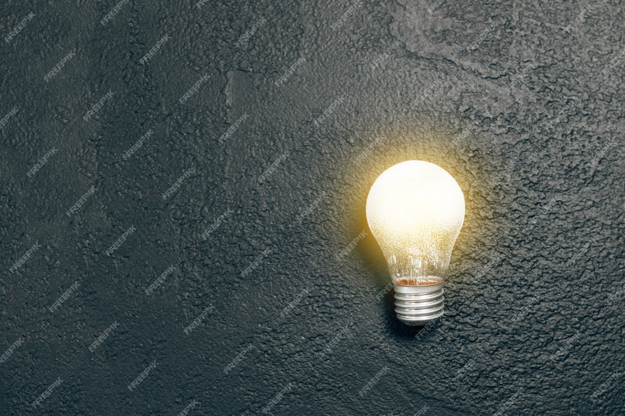 Premium Photo | Bright glowing light bulb idea on a dark grunge blackboard  background creative