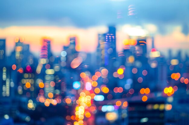 Bright glowing lights of district in megapolis under dusk sky in evening on blurred background