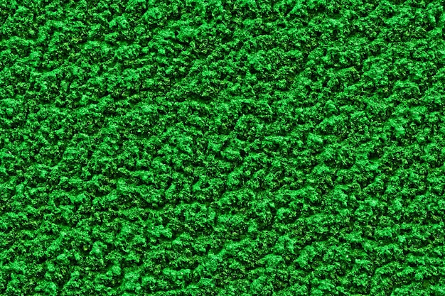 Bright green solid background with rough plaster texture