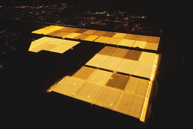 Bright greenhouses at night with a bird's eye view