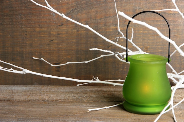 Photo bright iconlamp with branches on wooden background