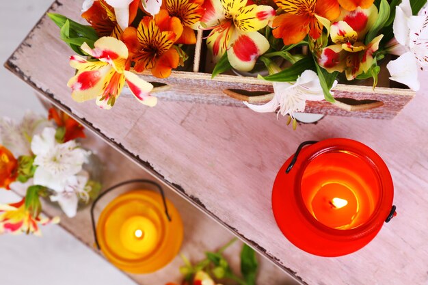 Photo bright iconlamps with flowers on wooden ladder on light background