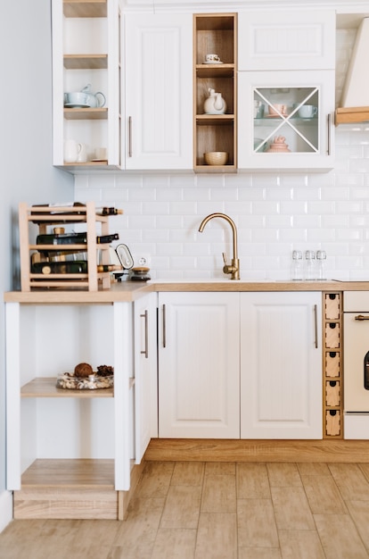 Bright kitchen in the Scandinavian style with dishes and kitchen accessories on the table.