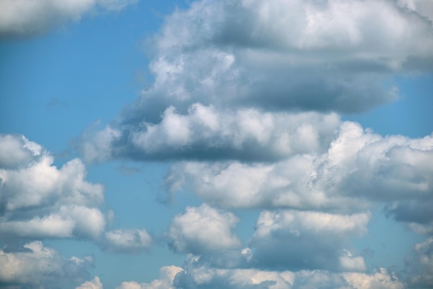 Bright landscape of white puffy cumulus clouds on blue clear sky