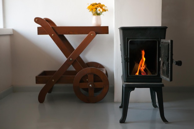 Bright living room interior with fireplace chimney made of metal relaxing ambiance and heating