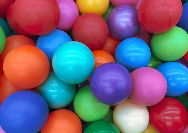 Bright multi-colored balls for the pool for childrens games.Toys for children,entertainment for kids.Use in catalogs of childrens stores,advertising entertainment centers.Bright multi-color background