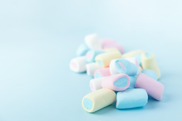 Bright multicolored marshmallows on a blue background