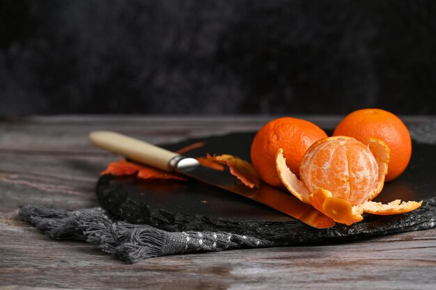 Bright orange clementine tangerines lie on the table