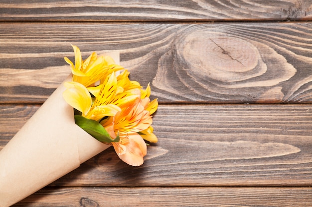 Photo bright orchid flowers are packaged in kraft paper.