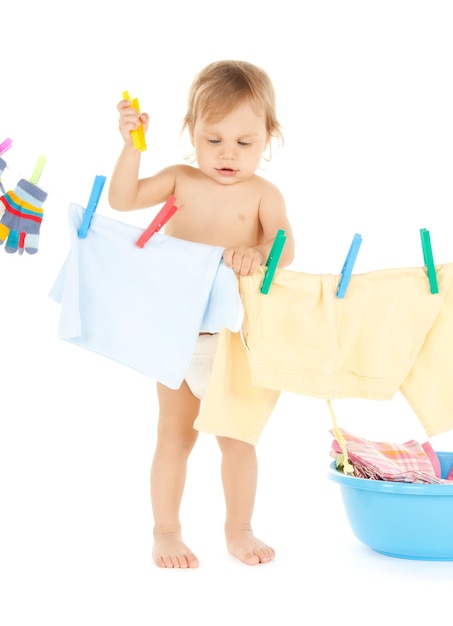 bright picture of adorable baby doing laundry .