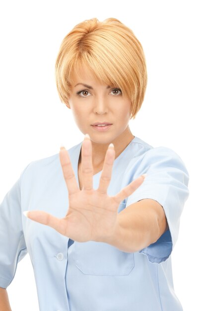 bright picture of attractive female doctor showing stop gesture