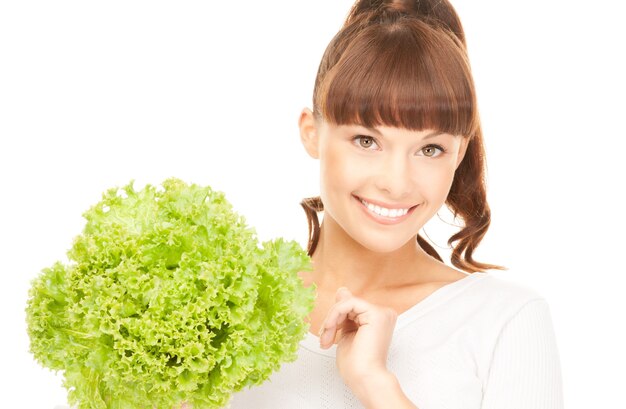 bright picture of beautiful housewife with lettuce over white