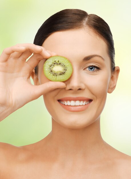 bright picture of beautiful woman with kiwi slice