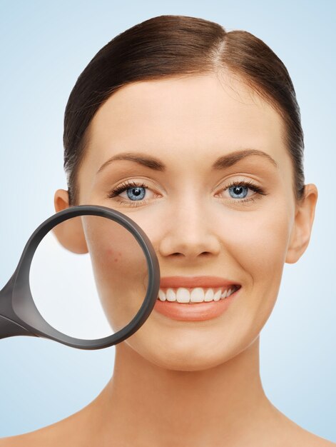 bright picture of beautiful woman with magnifying glass over acne