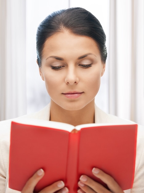 bright picture of calm and serious woman with book