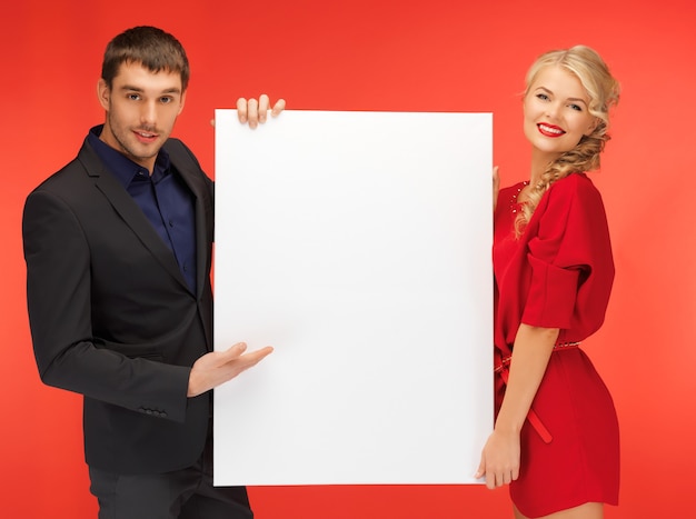 bright picture of couple holding big blank board