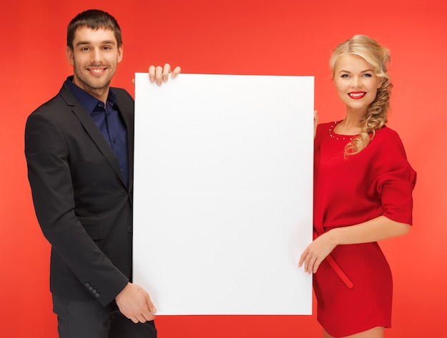 bright picture of couple holding big blank board