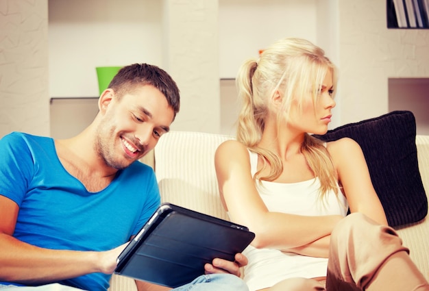 bright picture of couple with tablet PC (focus on man)