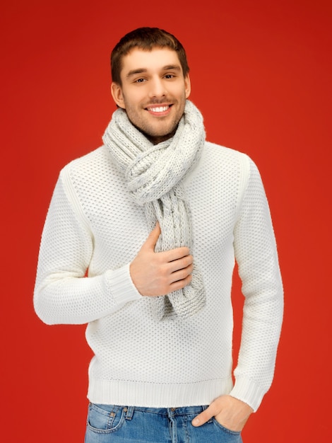 bright picture of handsome man in warm sweater and scarf.