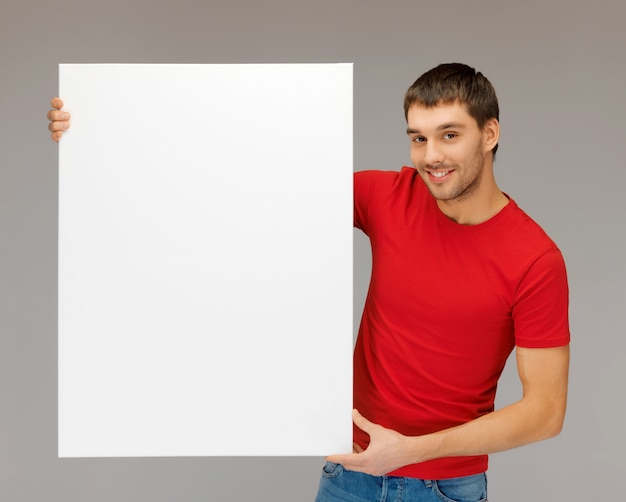 bright picture of handsome man with big blank board.