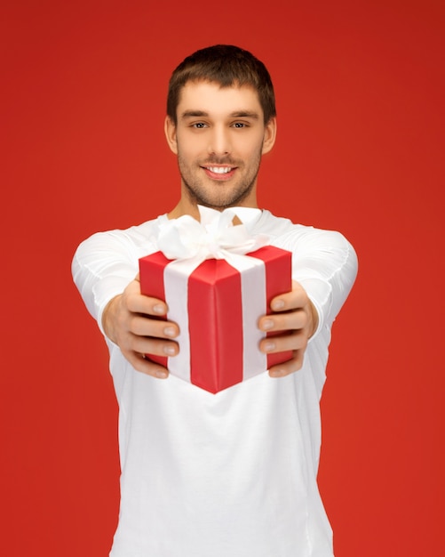 bright picture of handsome man with a gift .