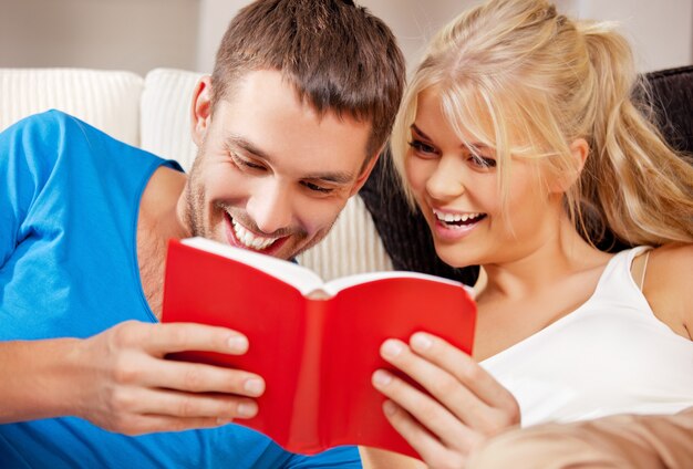 bright picture of happy couple with book (focus on man)