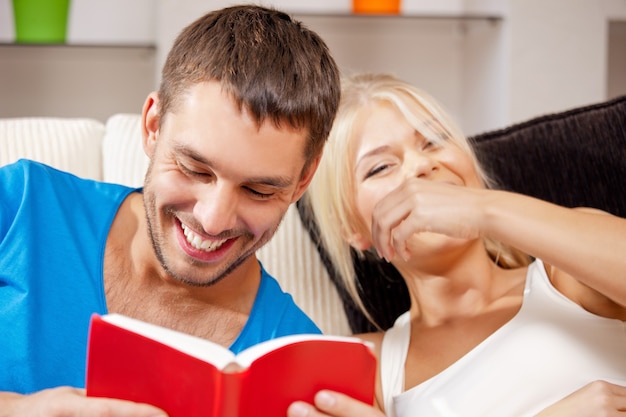 bright picture of happy couple with book (focus on man)