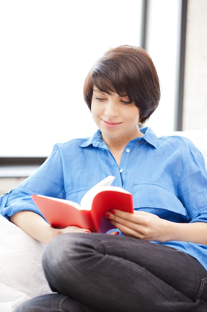 bright picture of happy and smiling woman with book