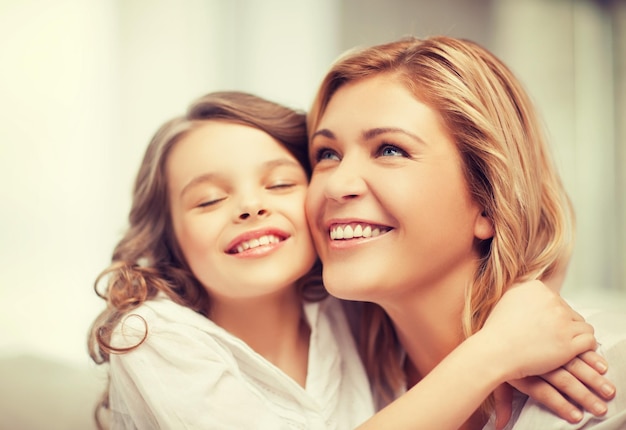 bright picture of hugging mother and daughter