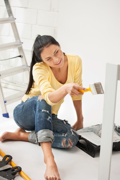 bright picture of lovely housewife painting at home