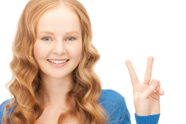 bright picture of lovely teenage girl showing victory sign