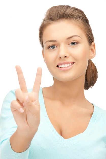 bright picture of lovely teenage girl showing victory sign