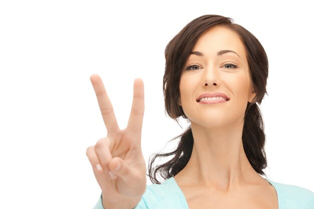 bright picture of lovely teenage girl showing victory sign