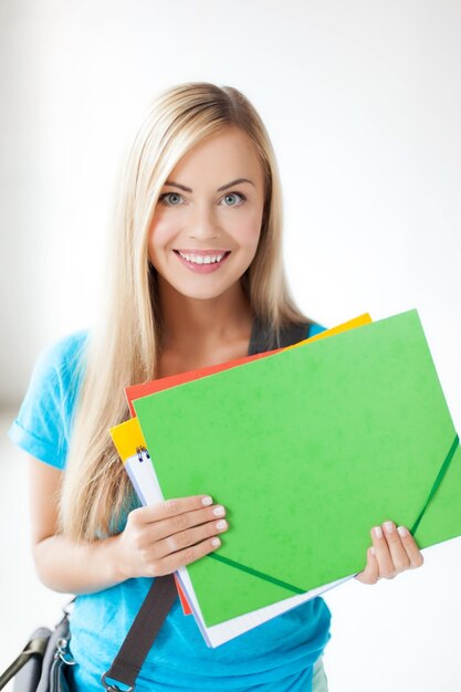 bright picture of smiling student with folders