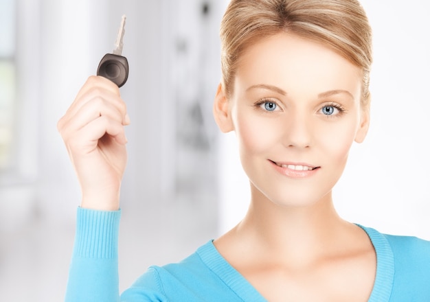 bright picture of smiling woman with car key