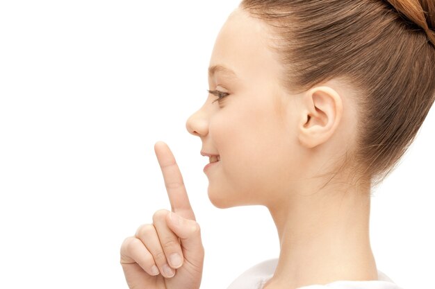 Photo bright picture of teenage girl with finger on lips