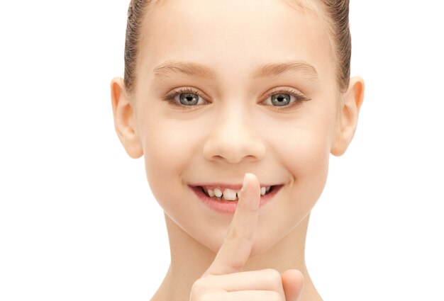 bright picture of teenage girl with finger on lips