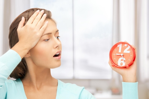 bright picture of woman holding alarm clock