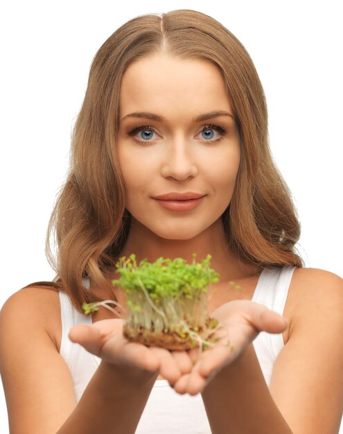 bright picture of woman with green grass on palms