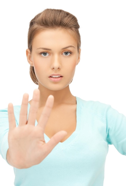 bright picture of young woman making stop gesture..