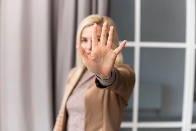 Bright picture of young woman making stop gesture