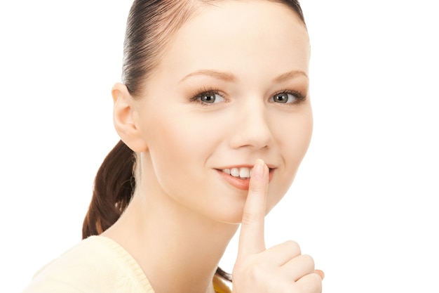 bright picture of young woman with finger on lips