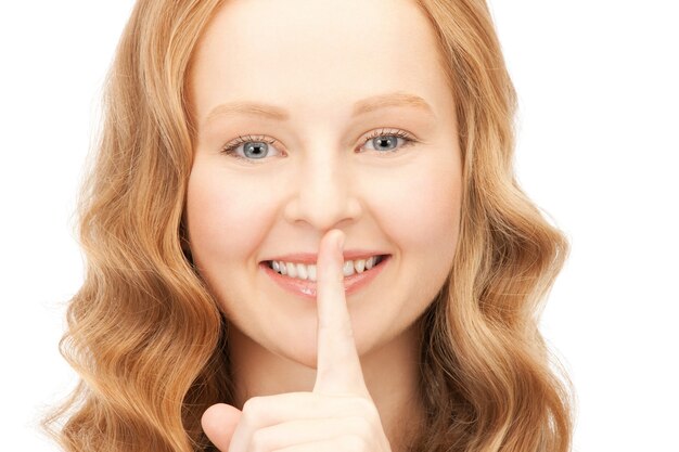 bright picture of young woman with finger on lips