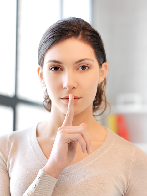 bright picture of young woman with finger on lips