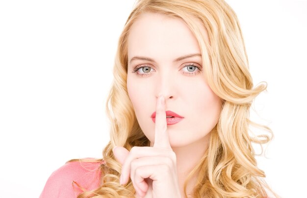 bright picture of young woman with finger on lips