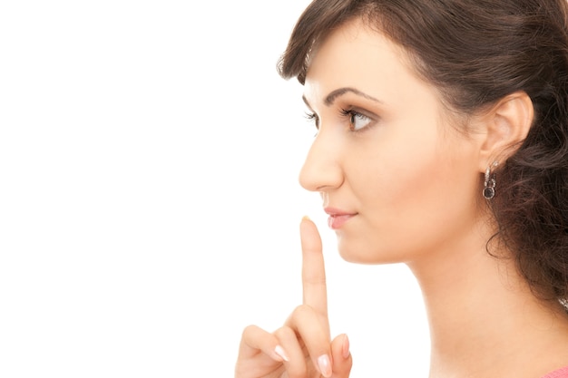 bright picture of young woman with finger on lips